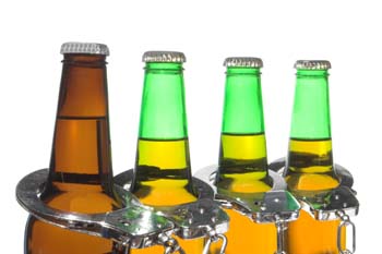 Excessive Drinking Can Lead To DUI Arrest - Beer Bottles & Handcuffs