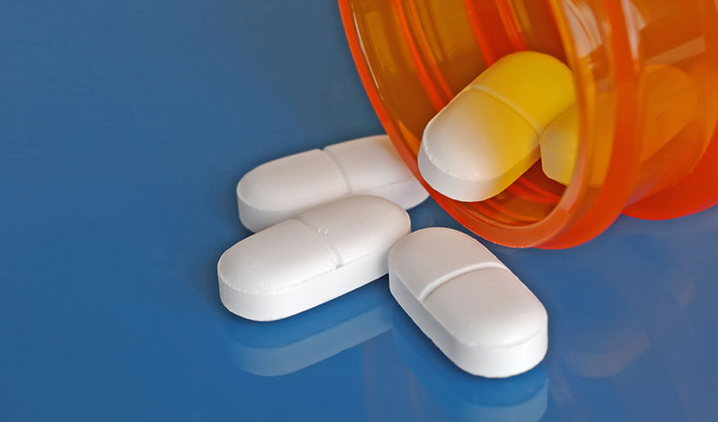 Prescription Pills Flowing Out of Pill Bottle